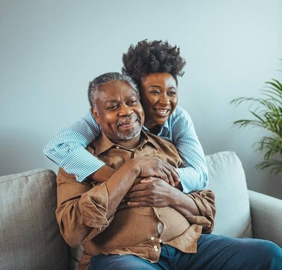 A Storge caregiver sitting and talking with a client at home